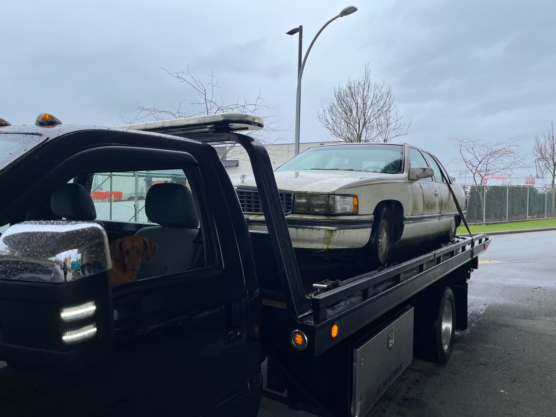 A sedan loaded on the flatbed of Jay's tow truck in Vancouver